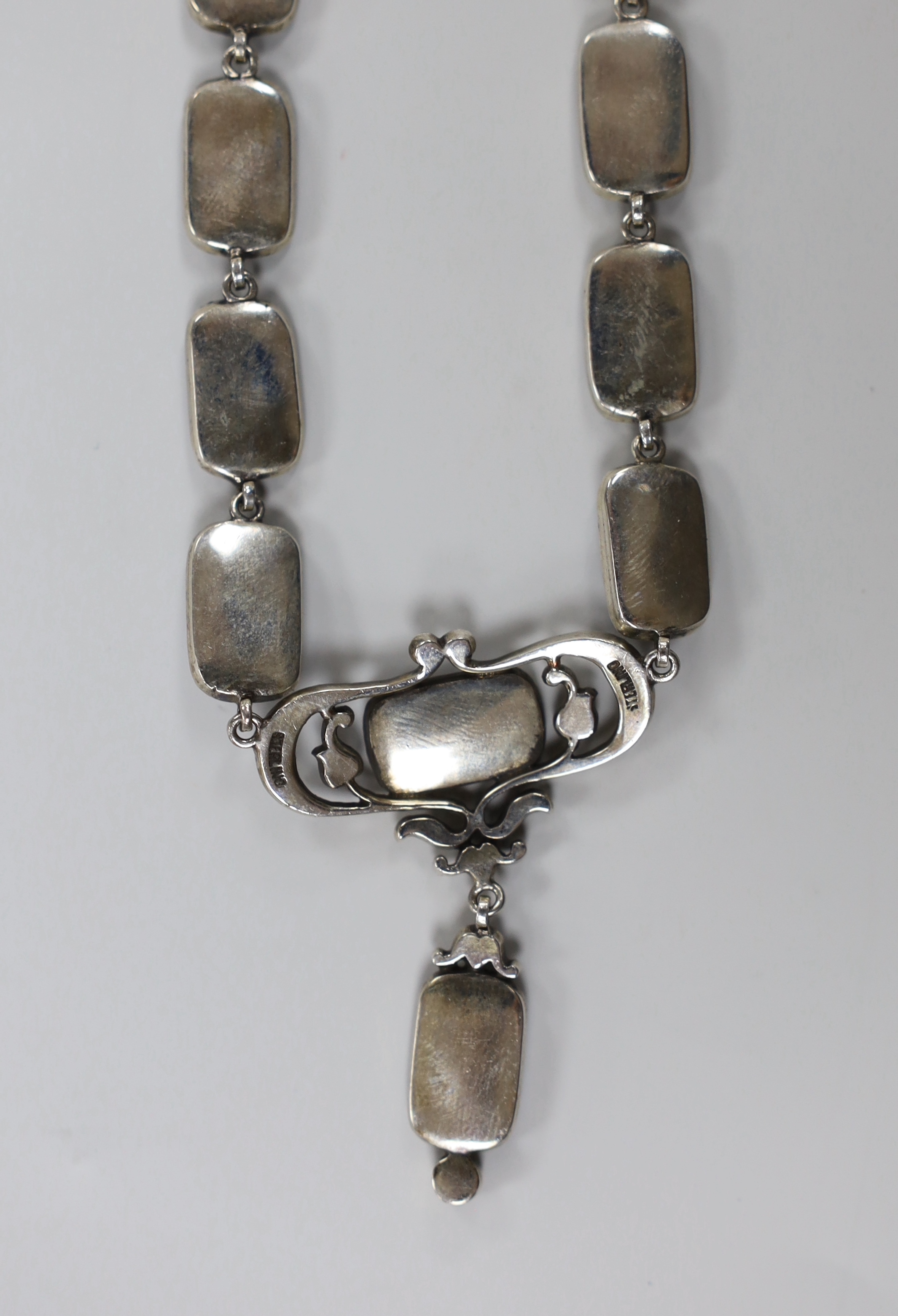 A stylish sterling, paste and blue enamel set drop pendant necklace, overall 43cm.